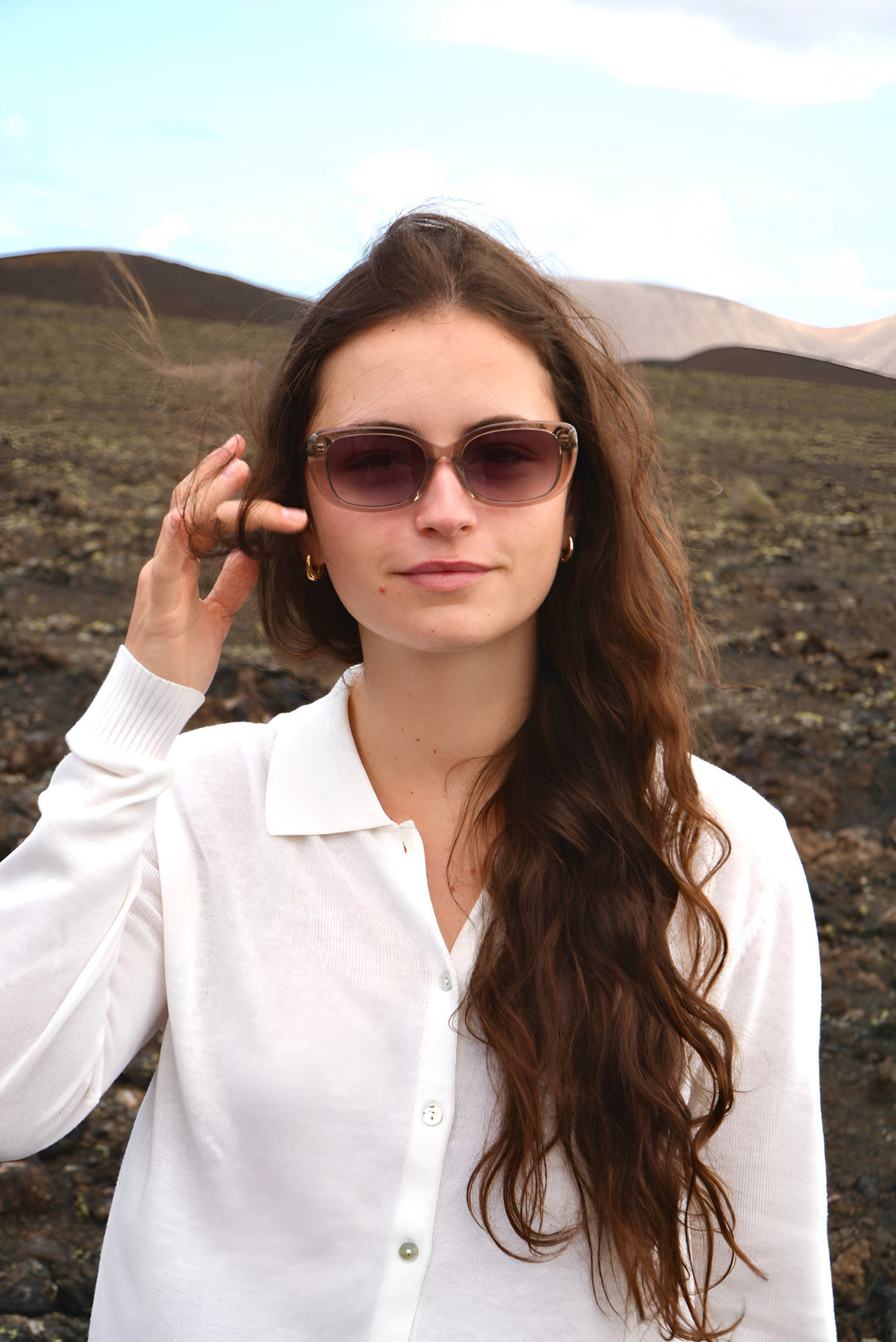 Mujer con gafas de sol de acetato Di Capo en paisaje natural